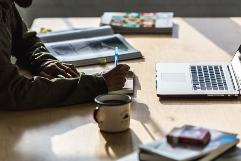 man-writing-at-desk